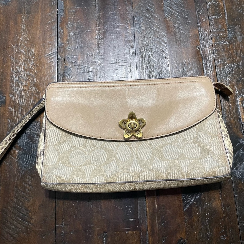 Coach wristlet in very good cond. Signature light tan with snake skin accents.